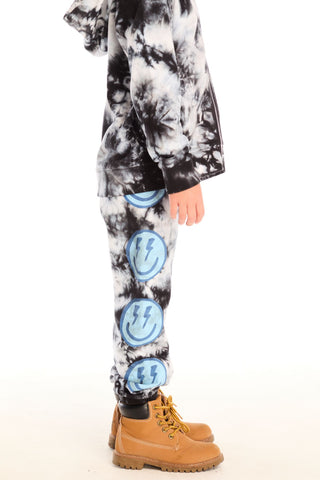 Chaser Smiley Bolt Pants
Person wearing tie-dye pants with lightning bolt designs and brown boots on a white background