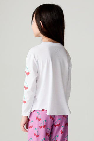Chaser Sweethearts Girls Tee
A child shown from the back wearing a white long-sleeve top with a red and green cherry print down one sleeve and pink pants with a matching cherry pattern, against a light gray studio background.