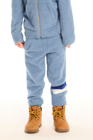 Chaser Tahoe Blue Lounge Pant With Pocket
Person wearing a blue knit sweater and pants with brown boots on a white background