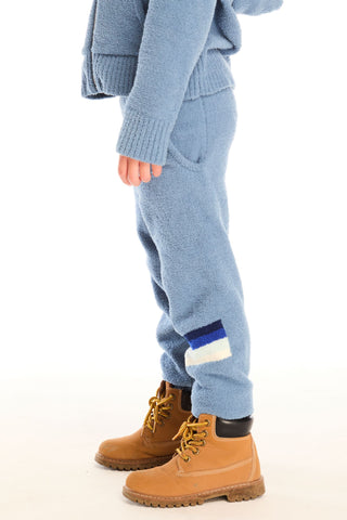 Chaser Tahoe Blue Lounge Pant With Pocket
Person wearing a blue knit outfit with brown boots on a white background
