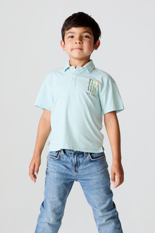 Chaser Tee Time Short Sleeve 
Child wearing a light blue polo shirt and jeans on a plain background