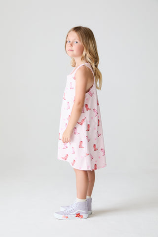 Chaser These Boots Allover Dress
Young girl wearing a pink dress with red patterns on a white background