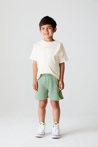 Chaser Wide Leg Wave Stripe Leaf Green Shorts
Child wearing a beige t-shirt and green shorts on a white background