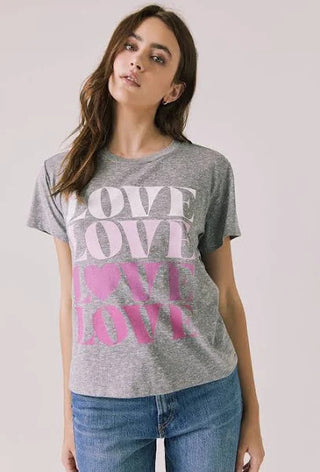 Chaser Women's Love Tee
Woman wearing a gray t-shirt with 'LOVE' printed in pink on a plain background