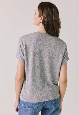 Chaser Women's Love Tee
Person wearing a gray t-shirt and blue jeans against a plain background