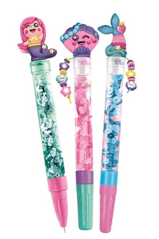 Clementoni Idea Create Your­ Pens – Magical Mermaids
Three colorful novelty gel pens with mermaid-themed tops, shown on a plain white background. The pens feature pink, teal, and blue designs with glitter, beads, and cartoon mermaid figures.
