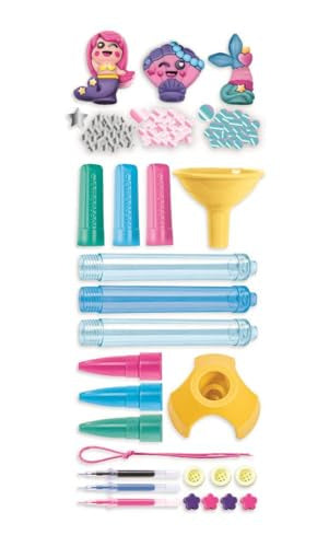 Clementoni Idea Create Your­ Pens – Magical Mermaids
A colorful craft or toy accessory set laid out on a white background, including small character figurines, patterned pieces, green and blue tubes, a yellow funnel, pink and blue cone-shaped pieces, clear cylindrical tubes, a yellow stand, small tools, and decorative buttons.