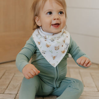 Copper Pearl Wilder Bandana Bib Set
Baby wearing a green outfit and a bib with animal prints on a wooden floor.