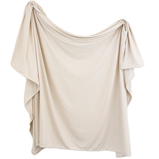 Lou Lou and Company Ribbed Swaddle Blanket - Cove
Beige off-shoulder top on a white background