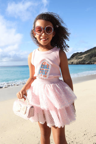 Lola and The Boys Crystal Chill Out Tank Top
Young girl in a pink outfit with sunglasses standing on a beach.