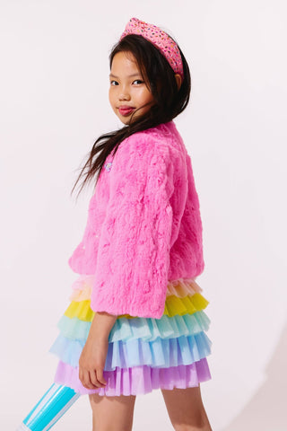 Lola and The Boys Cutie Charms Faux Fur Jacket
Child wearing a pink fluffy jacket and colorful layered skirt with a pink tiara on a white background