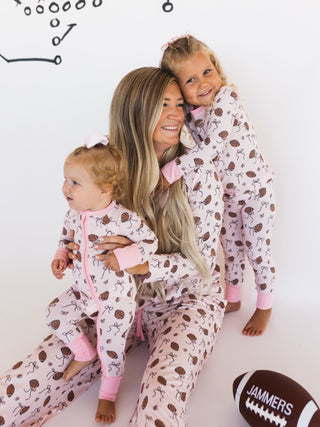 In My Jammers Blush Football Two Piece Set
Woman and two children in matching pajamas with a football and 'Jammers' text in the background.