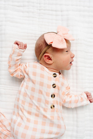 Lou Lou and Company Evie knotted gown for babies, soft fabric with a charming knotted design and pastel color, perfect for little ones.
