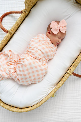 Lou Lou and Company Evie swaddle blanket with soft, cozy fabric featuring a charming pattern, ideal for wrapping a baby.