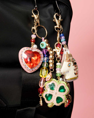 Super Smalls Royal Heart Bag Charm
Colorful keychain with heart, clover, and unicorn charms on a black background