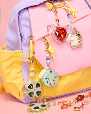 Super Smalls Super Unicorn Bag CharmColorful keychains with heart and flower designs on a pink and yellow backpack.