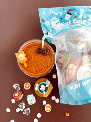 EGKD Earth Grown KidDoughs Cat Cafe KidDough Play Kit 
Cup of coffee with a bear-shaped foam art and a small bag labeled 'Cat Cafe' on a brown surface.