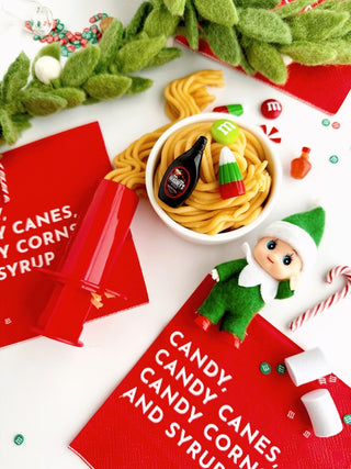 EGKD Earth Grown KidDoughs Elf Breakfast KidDough Play Kit 
Christmas-themed setting with candy, an elf figurine, and a bowl of pasta.
