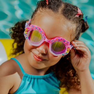 Bling2o Enchanted Shoreline Seashell Swim Goggles
Child wearing colorful swim goggles with a pool background