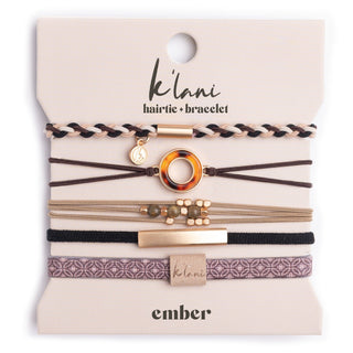 K'lani "Ember" with Tortoise Shell Ring Charm Hair Tie Bracelets
A set of thin elastic hair ties with gold-toned metal rings and patterned bands, displayed on a beige backing card. The card shows the brands 'kiki' and 'embar' in black text.