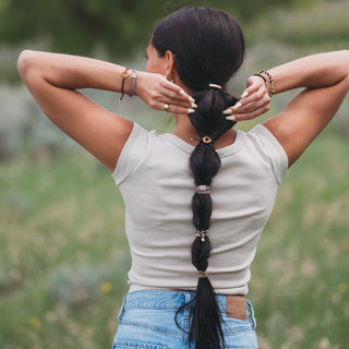K'lani "Ember" with Tortoise Shell Ring Charm Hair Tie Bracelets
Woman with a long braid standing in a field