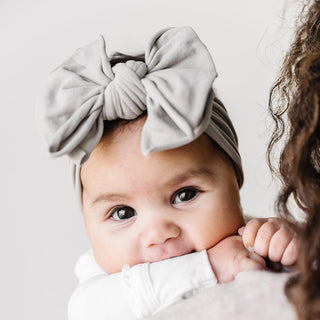 Baby Bling FAB grey headband featuring a soft fabric band with a stylish bow for babies or toddlers.