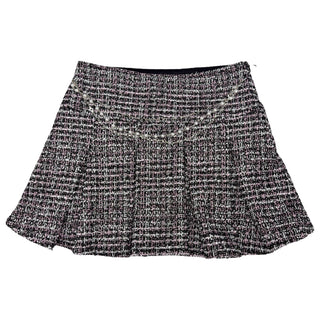 FBZ Black & Pink Tweed Skirt
A black and white tweed mini skirt with a textured woven pattern and a pleated flared silhouette, shown flat against a white background.