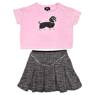 FBZ Black & Pink Tweed Skirt
A two-piece girls' outfit set featuring a light pink short-sleeve crop top with a black dachshund wearing sunglasses graphic, paired with a black and white tweed pleated skirt.