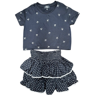 
Navy blue crop top with white bow pattern and matching polka dot shorts on a white background
