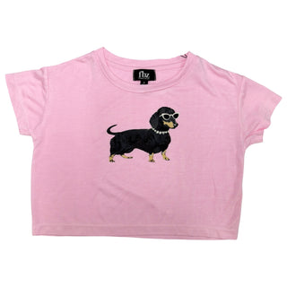 FBZ Dog on Pink Jersey Boxy Tee
A light pink short-sleeve baby tee featuring a graphic illustration of a black dachshund wearing sunglasses on the front, displayed flat against a white background.