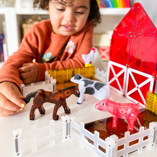 Magna-Tiles Farm™ 25-Piece Set
Child playing with farm toy set including animals and barn