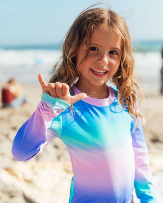 Feather 4 Arrow Wave Chaser Sunset Sky rashguard, one-piece swimwear with vibrant sunset sky design, for sun protection and active beach days.