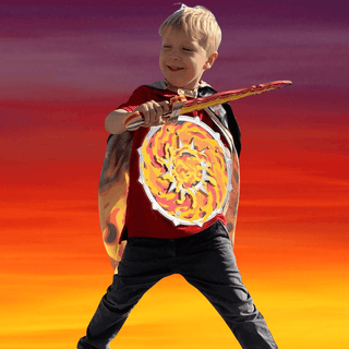 Liontouch Sword - Fantasy Flame
Child in a superhero costume holding a shield against a colorful sunset background