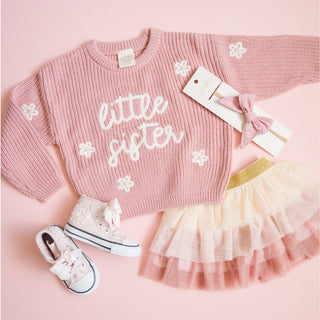 Sweet Wink Little Sister Knit Sweater
Pink 'little sister' sweater with matching skirt and shoes on a pink background
