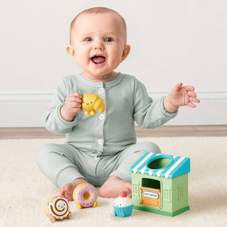 Itzy Ritzy Itzy Play™ Put & Take Toy - Bakery
Baby playing with colorful toys on a light wooden floor.