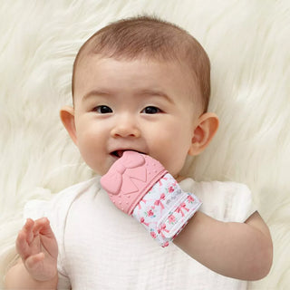 Itzy Ritzy Teething Mitt - Bow
Baby wearing a pink and white patterned baby rattle on a soft white background