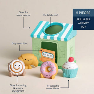 Itzy Ritzy Itzy Play™ Put & Take Toy - Bakery
Toy set with a bakery-themed house and four sweet-themed figures on a beige background.