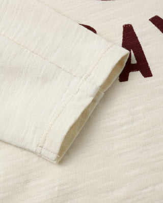 Rylee & Cru Long Sleeve Paneled Tee - Game Day
Close-up of a textured fabric with a brand logo on a white background