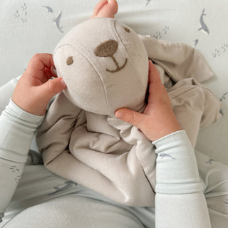 Gunamuna Bunny Lovey - Lucy
Child holding a soft toy resembling a bear with a neutral background