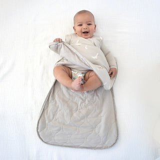 Gunamuna Sleep Sack 1.0 TOG - Goose
Baby wrapped in a gray swaddle on a white background