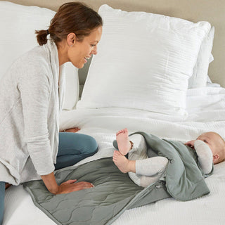 Gunamuna Sleep Sack 2.5 TOG - Sage
Woman and child under a gray weighted blanket on a bed