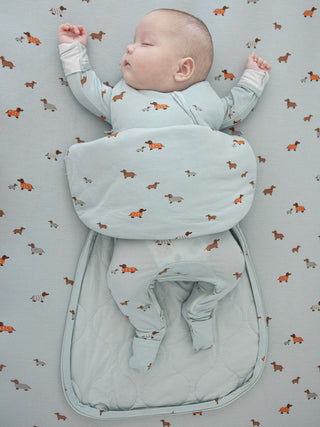 Gunamuna Swaddle Sleep Sack 1.0 TOG - Woof
Baby sleeping in a light blue sleeping bag with dog pattern on a matching blanket