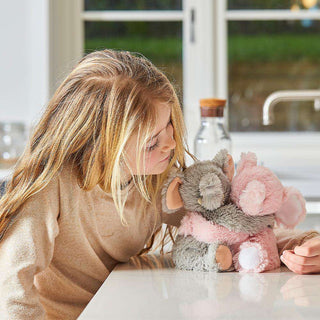 Warmies Elephant Hugs
Woman holding a pink and gray plush toy in a kitchen setting