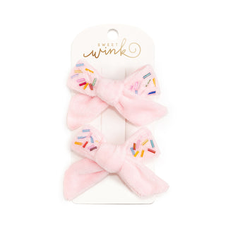 Sweet Wink Sprinkle Bow Clip Set
Pink hair bow with colorful sprinkles on a Sweet Wink branded card.