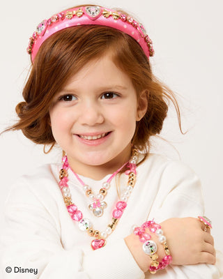Super Smalls Disney Minnie Mouse Jeweled Headband
Young girl wearing a pink tiara, necklace, and bracelets on a white background with Disney logo.