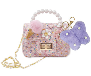 Hot Focus Tiny Mini Crossbody - Rainbow
Pink textured handbag with decorative elements and a purple butterfly charm on a white background