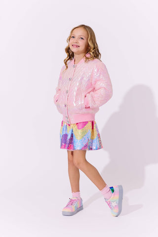 Lola and The Boys I Love You Hologram Jacket
Young girl wearing a pink sequin jacket, colorful skirt, and matching shoes on a white background