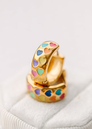 Pierced Co. Huggies - Chunky Rainbow Heart
Gold hoop earrings with colorful heart patterns on a white surface