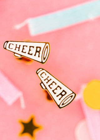 Pierced Co. Cheer Megaphone Earrings
Two 'CHEER' megaphone pins on a colorful background