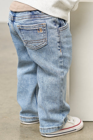 Little Bipsy Straight Leg Jean - Light Wash
Person wearing light blue jeans with a brand logo, standing on a neutral background